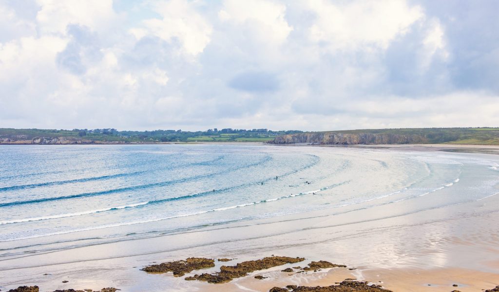 Sea bay with rolling waves at a sand beach a beautiful summer day